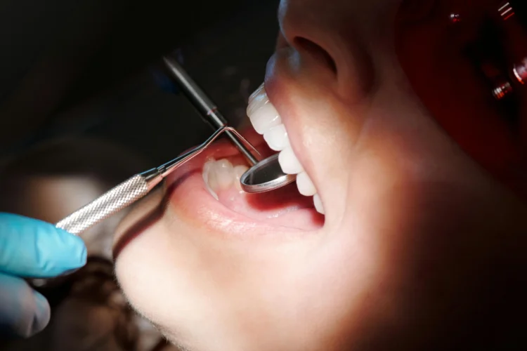 Dentist performing emergency dental check-up at 24/7 clinic