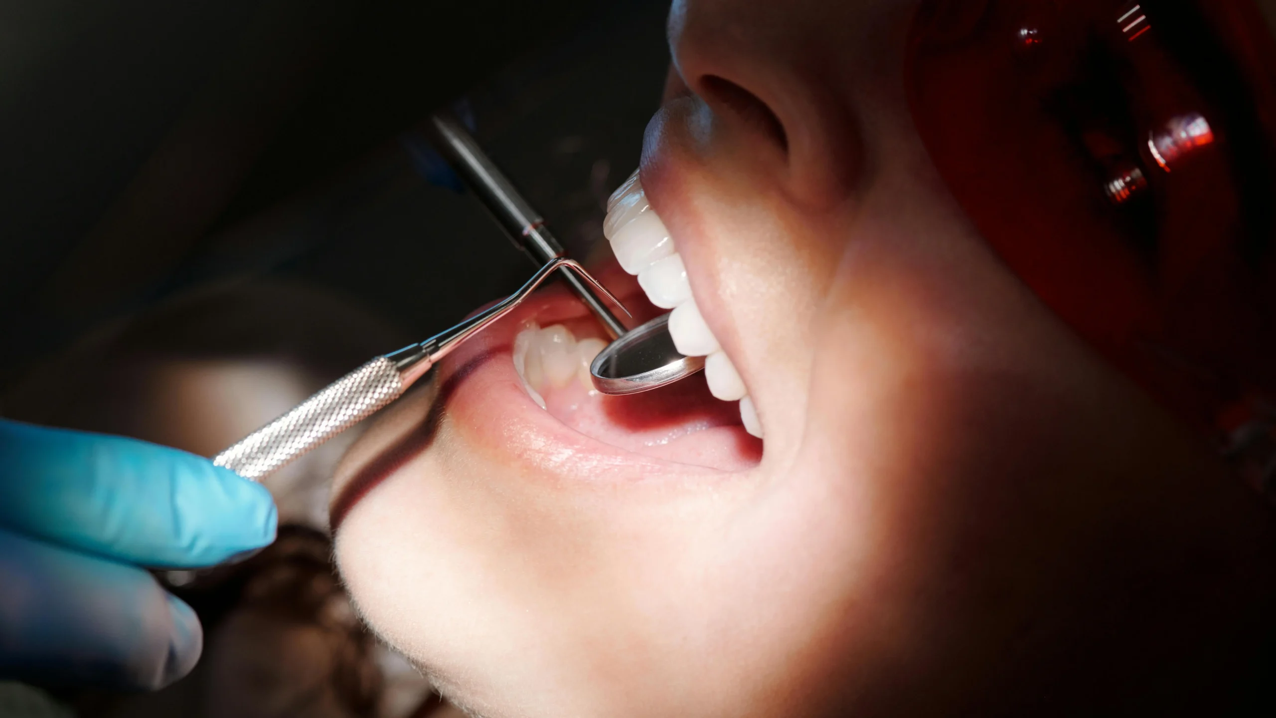 Dentist performing emergency dental check-up at 24/7 clinic