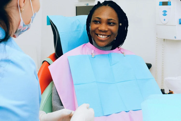 Dentist examining a woman, specialist dentists for complex cases