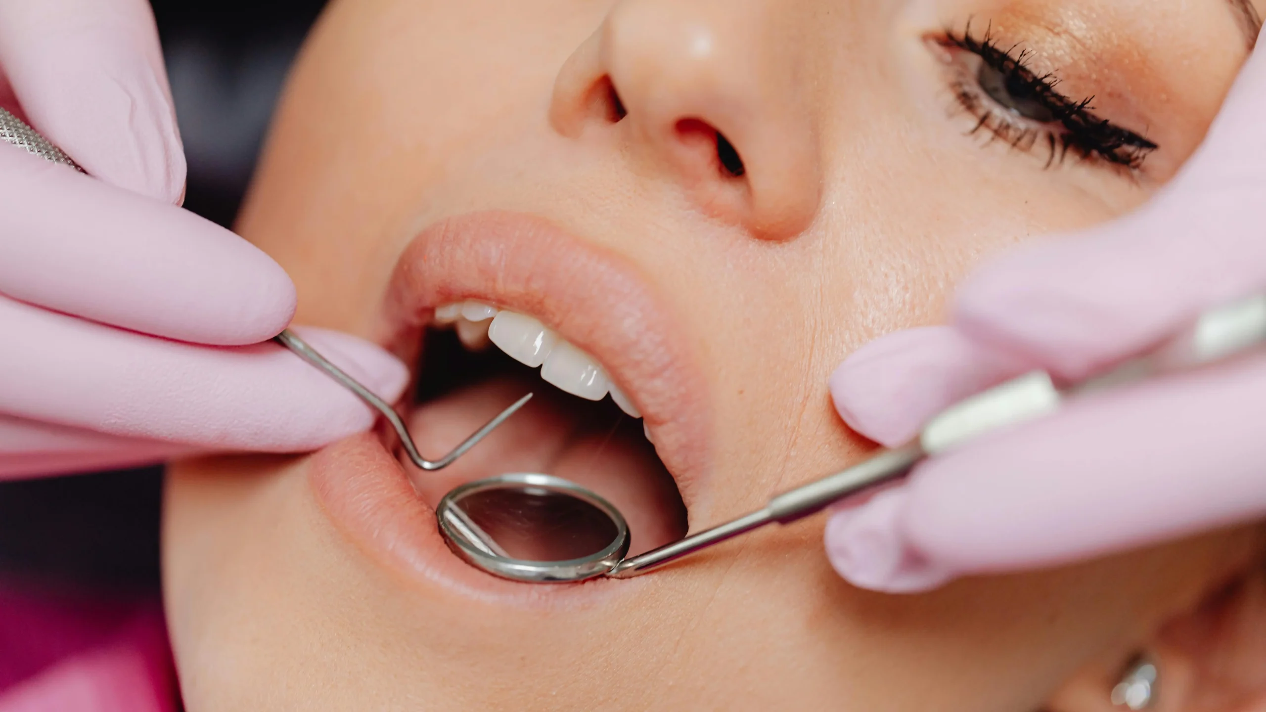 Woman receiving emergency dental repairs close-up