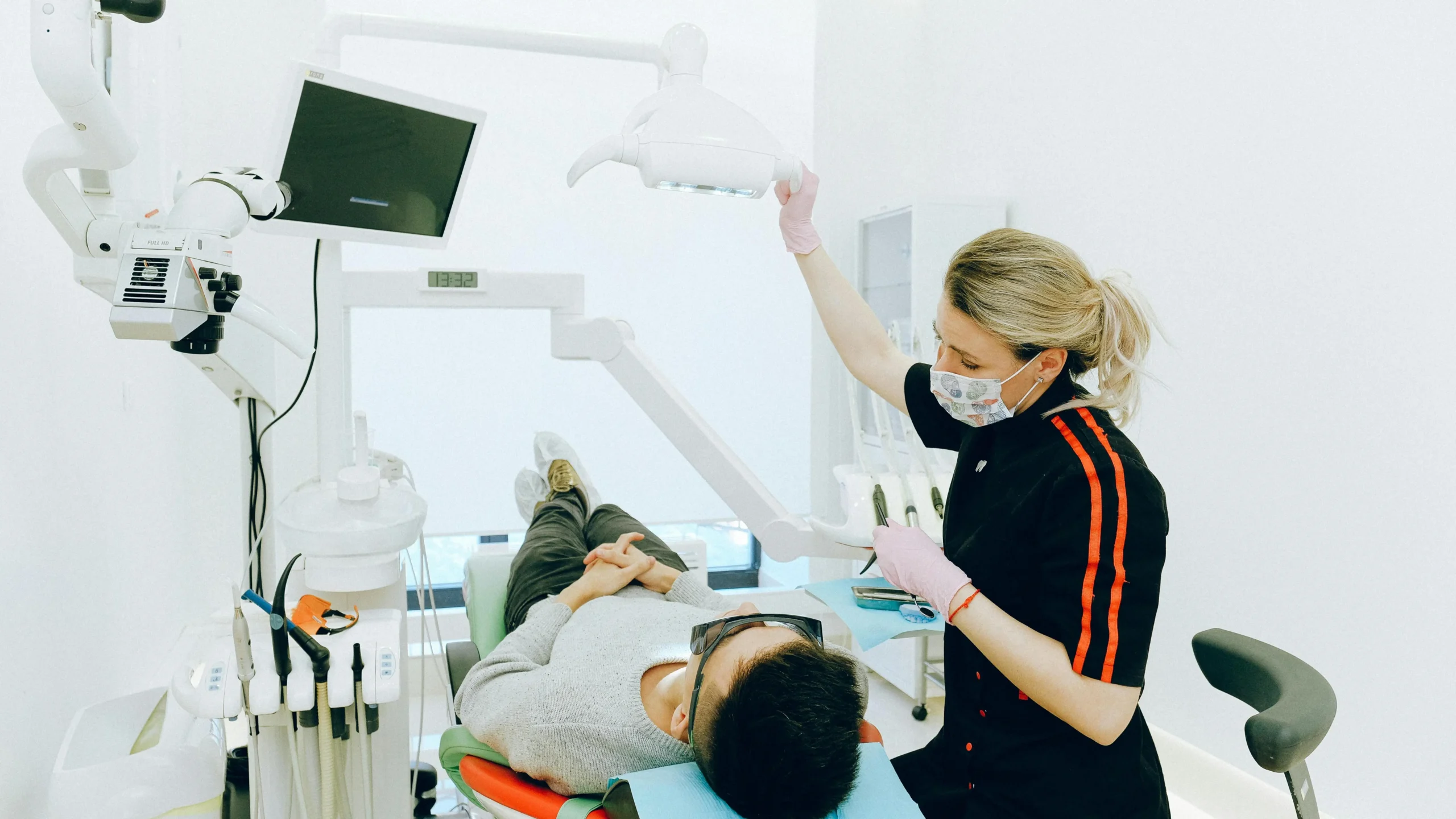 Experienced dental care professionals performing dental check-up on man