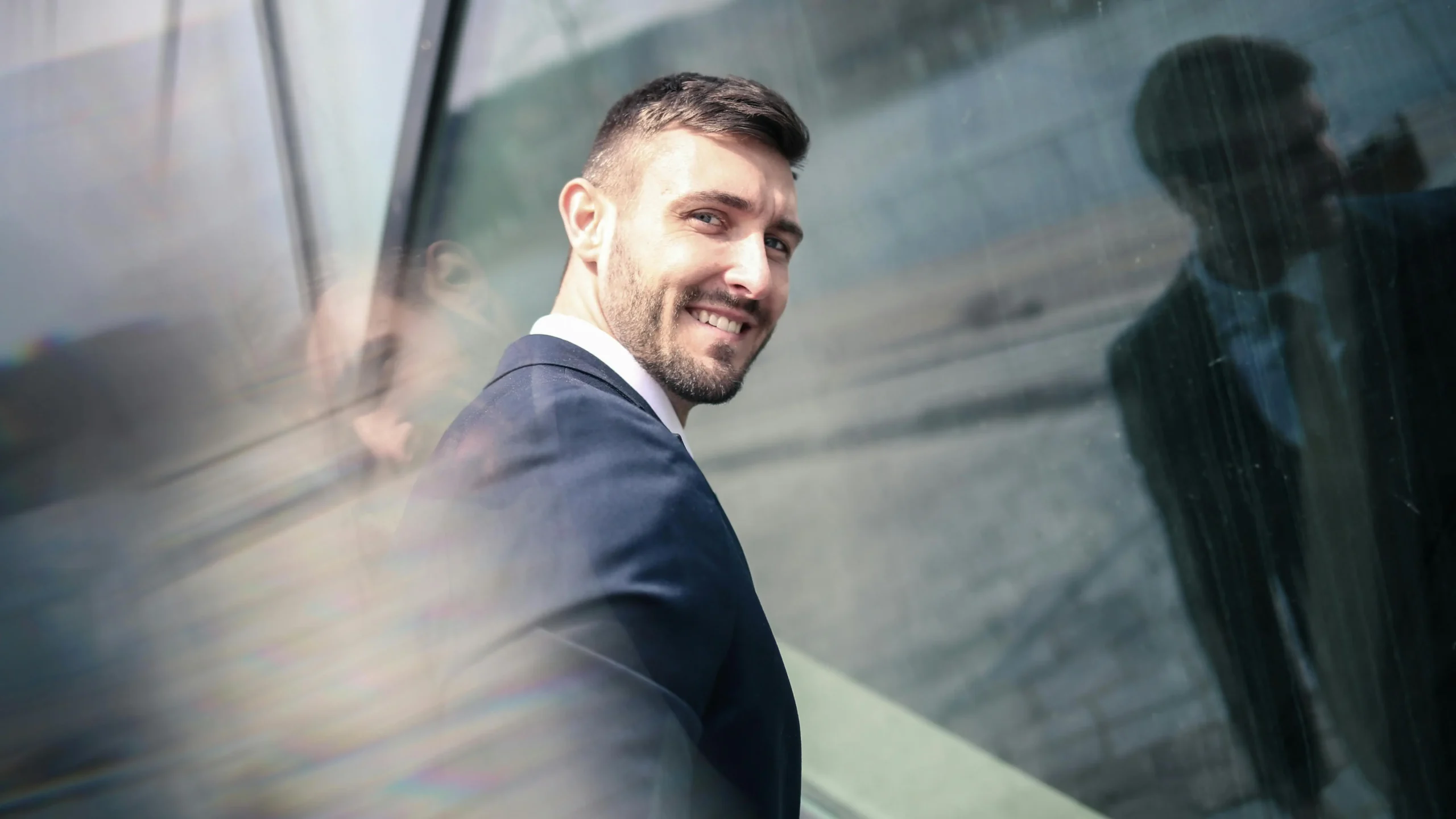 Cheerful businessman in formal wear showcasing his Invisalign for adults smile.