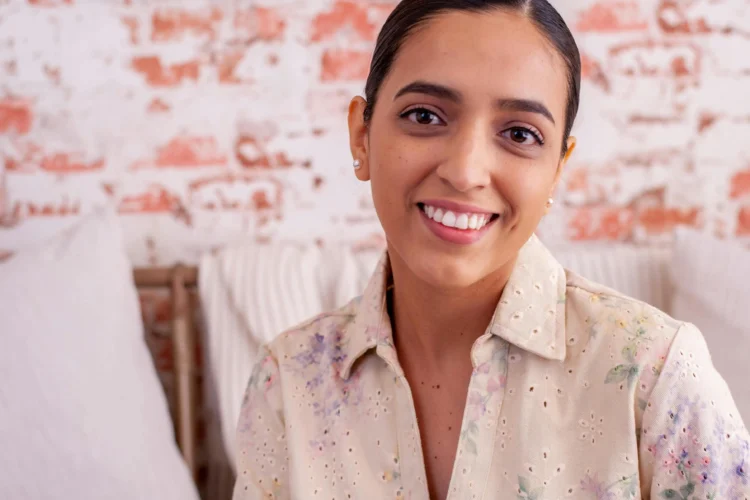 Smiling brunette showcasing results of Invisalign for underbites