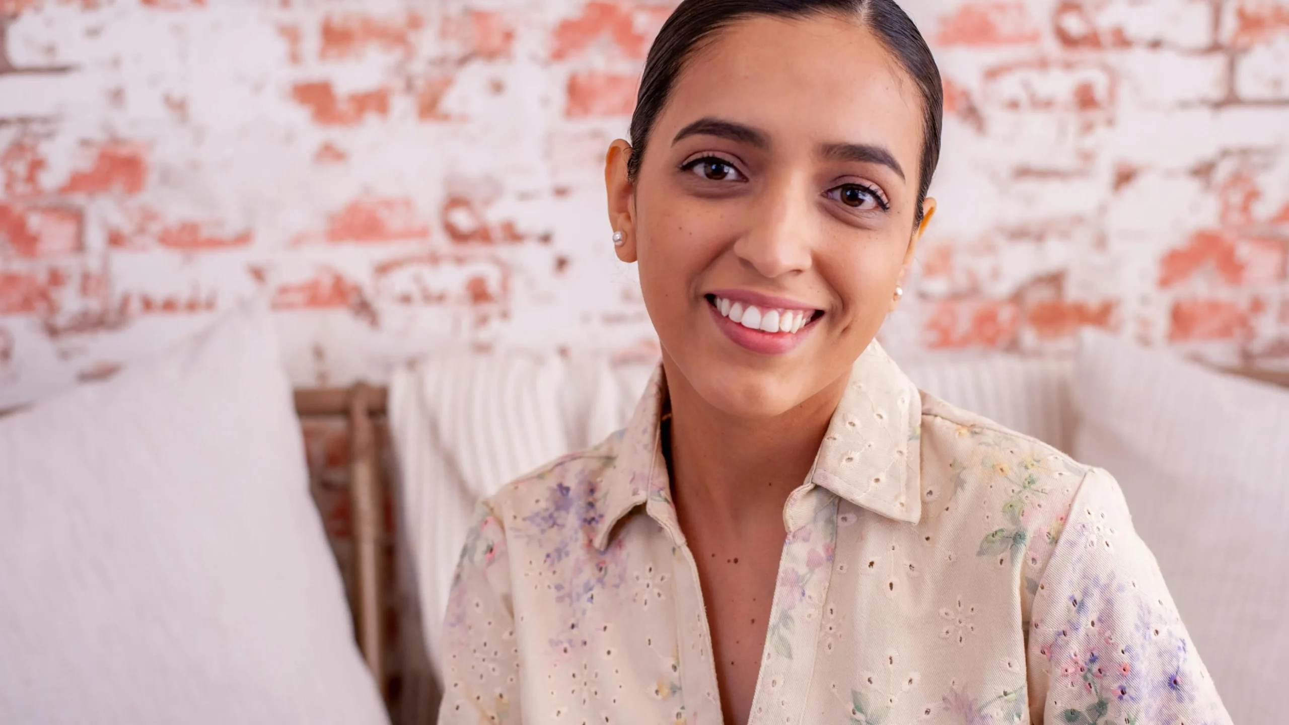 Smiling brunette showcasing results of Invisalign for underbites