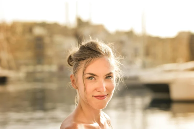 Smiling woman showcasing porcelain veneers