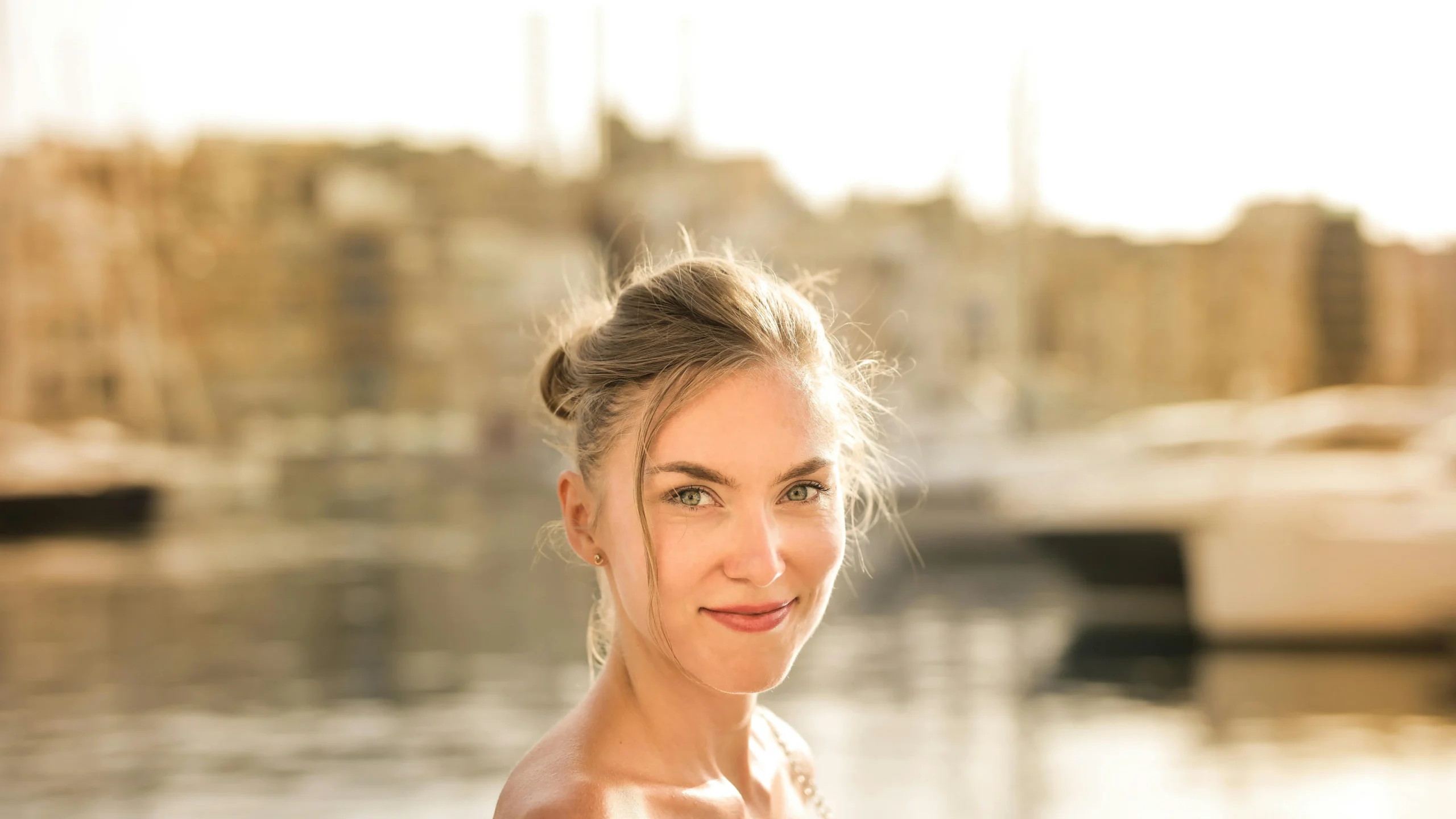 Smiling woman showcasing porcelain veneers