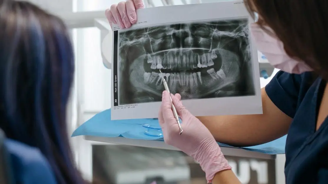 Dentist showing patient an X-ray for implant dentistry near me