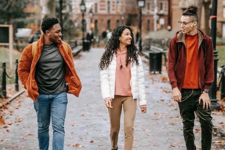 Happy friends walking together in the city, discussing Invisalign treatment options.