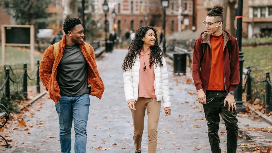 Happy friends walking together in the city, discussing Invisalign treatment options.