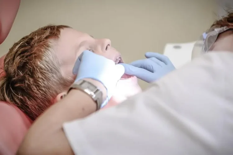 Kids dental specialists examining young boy's teeth