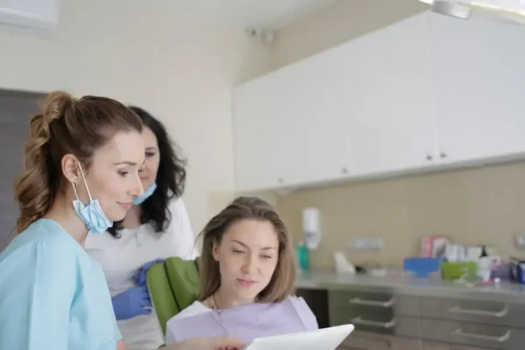 Patient consulting specialist dentist in Cookstown using a tablet