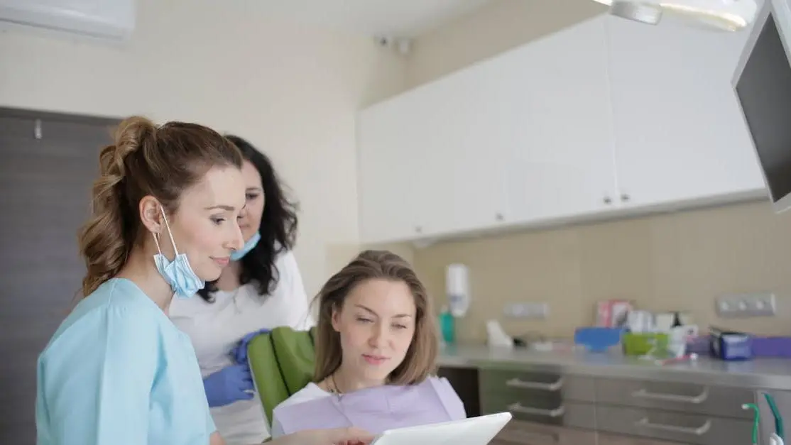 Patient consulting specialist dentist in Cookstown using a tablet