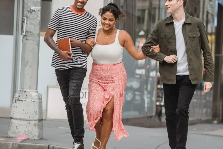 Diverse friends smiling, showcasing benefits teeth whitening on a zebra crossing