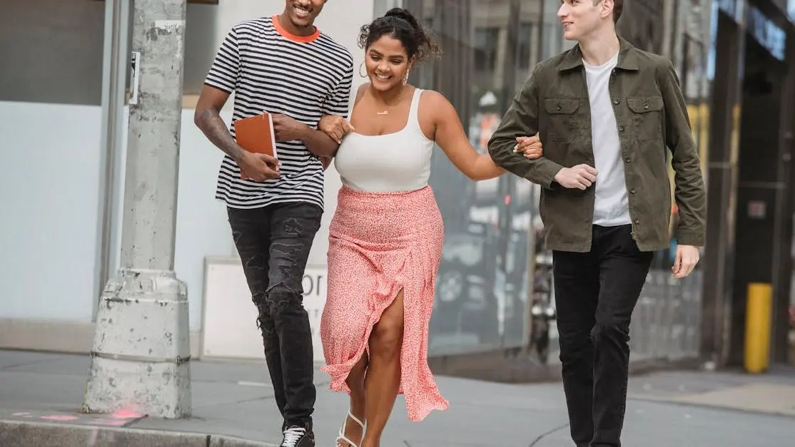 Diverse friends smiling, showcasing benefits teeth whitening on a zebra crossing