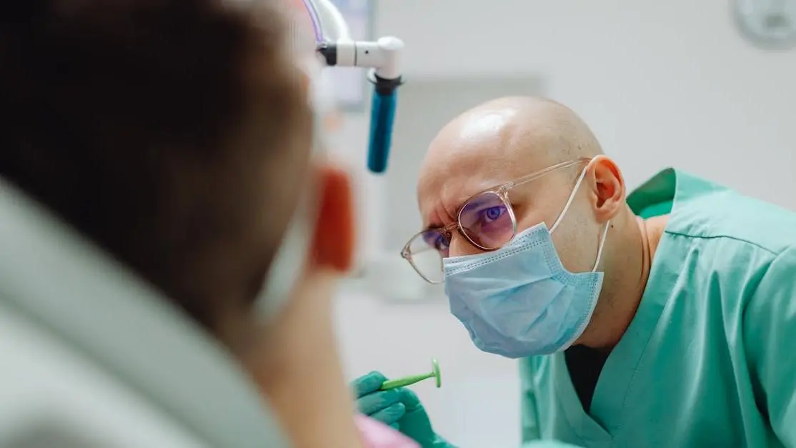 Deep sedation dentist examining a patient in a dental office.