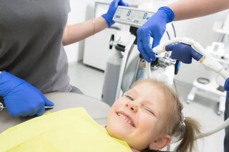 Girl smiling in dental chair at best pediatric dental specialists.