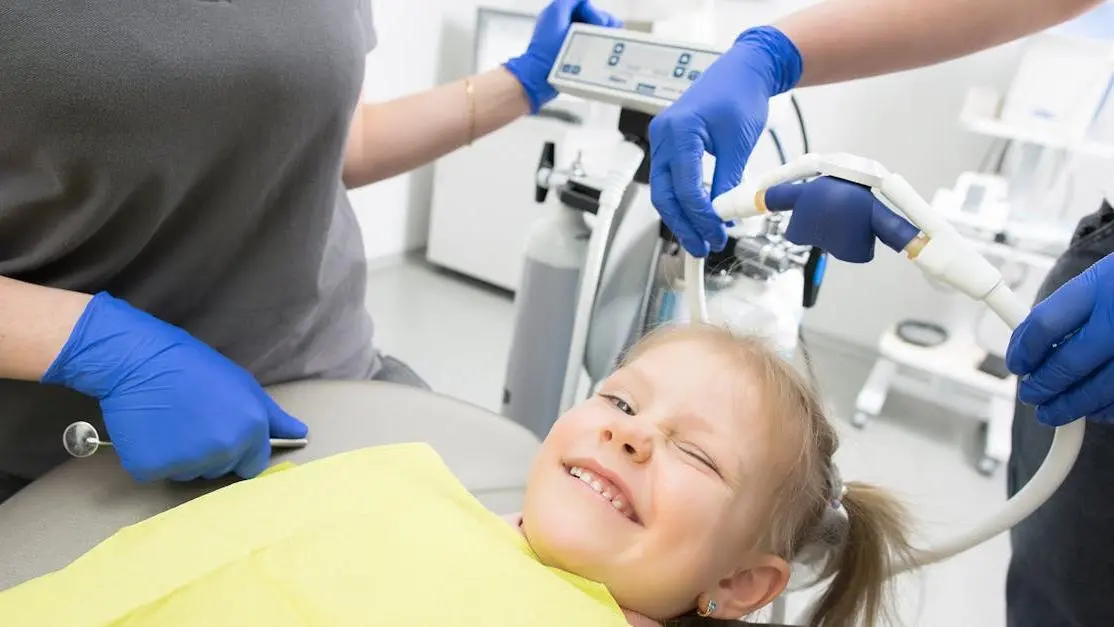 Girl smiling in dental chair at best pediatric dental specialists.