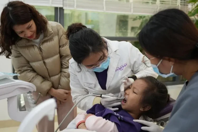 Child-friendly dentists providing care to a young patient in a welcoming environment.