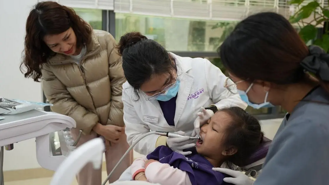 Child-friendly dentists providing care to a young patient in a welcoming environment.