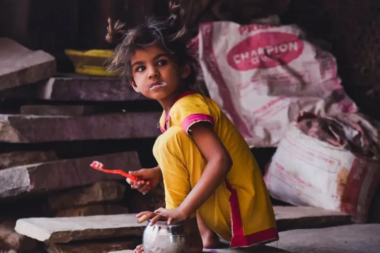 Girl in yellow brushing teeth, promoting children dental care