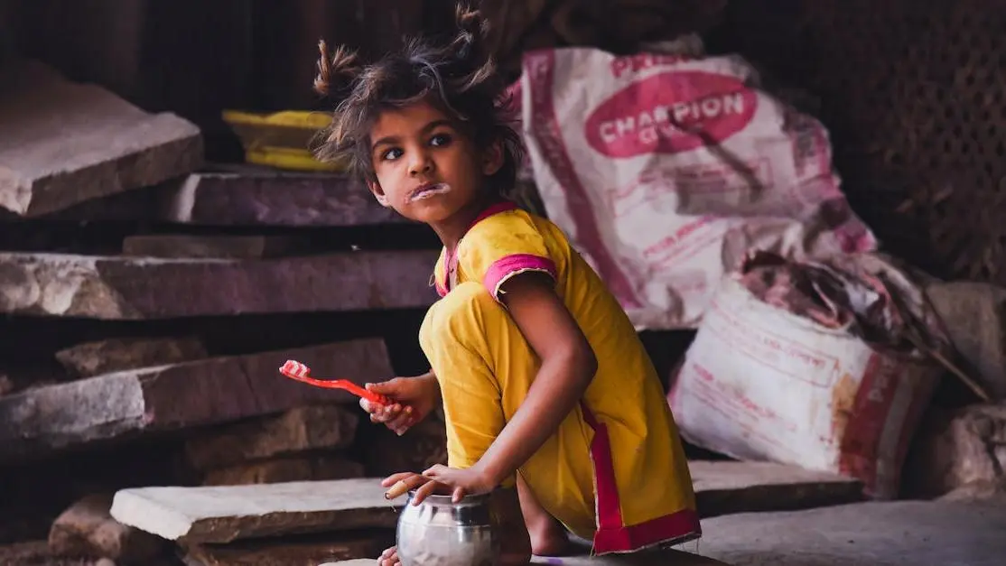 Girl in yellow brushing teeth, promoting children dental care