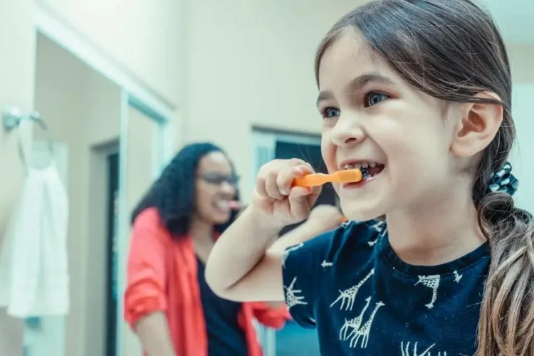 Child brushing teeth for children's oral hygiene.