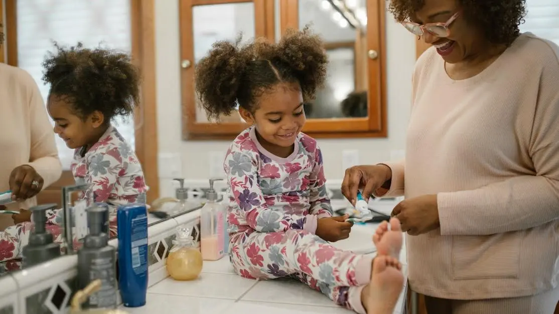 Mother and daughter practicing dental care, linked to cosmetic dentists near me.