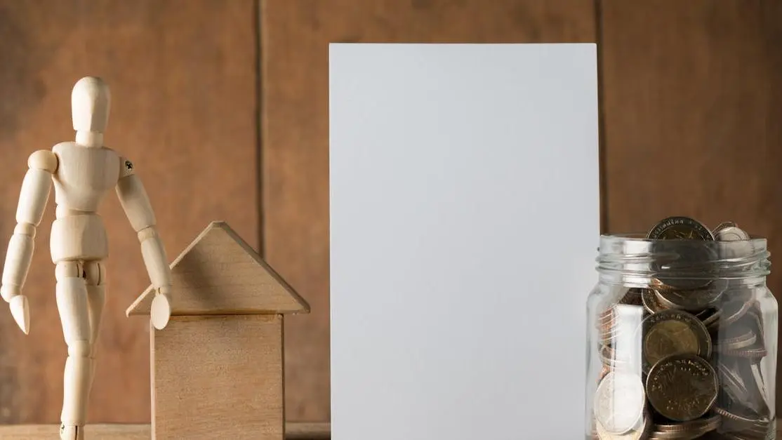 Money saving jar, blank paper, and wooden figurine for cost planning for braces