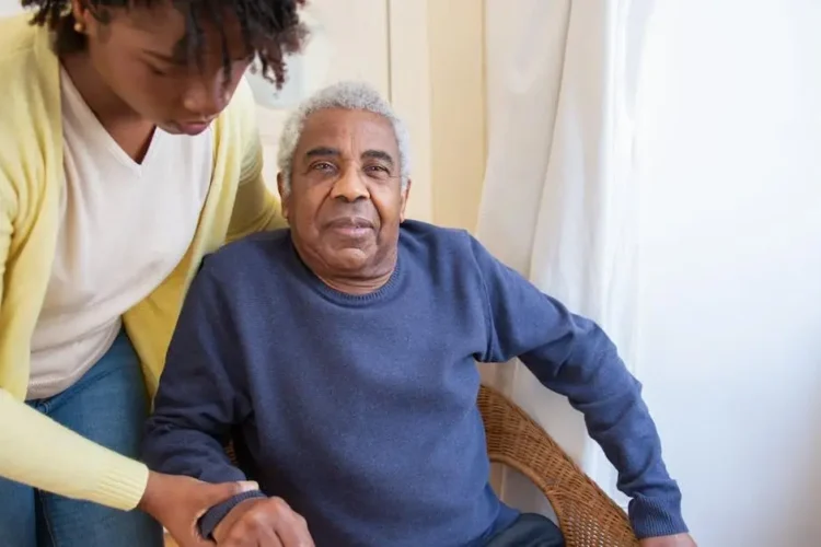 Elderly man receiving care in a dental home setting.