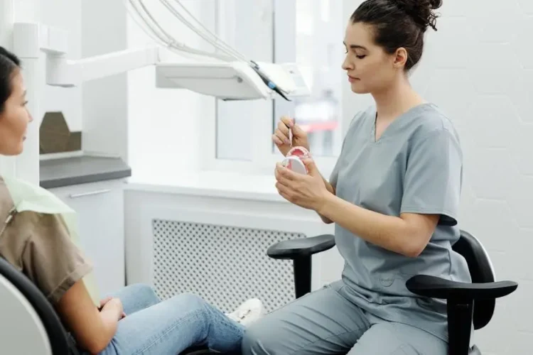 Dentist explaining dental procedure, addressing concerns about pain.