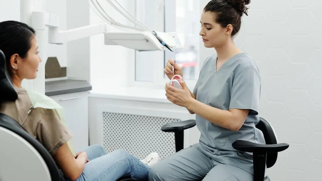 Dentist explaining dental procedure, addressing concerns about pain.