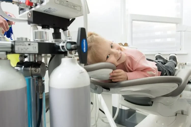 Child receiving dental sealants in a treatment chair