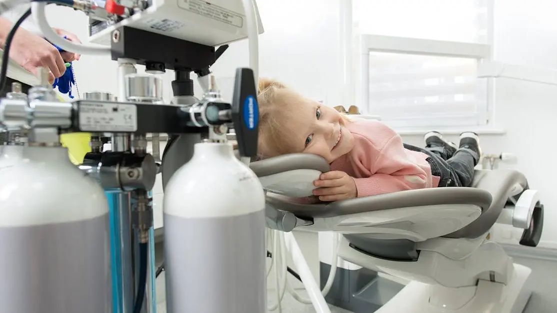 Child receiving dental sealants in a treatment chair