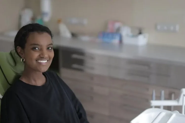 Young woman smiling in dental chair at clinic for dental sedation options