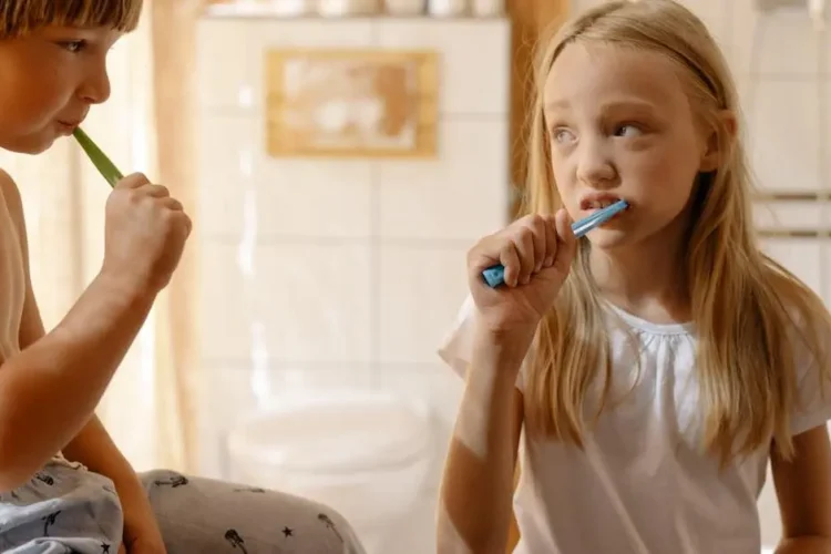 Children practicing oral hygiene to prevent early childhood caries.