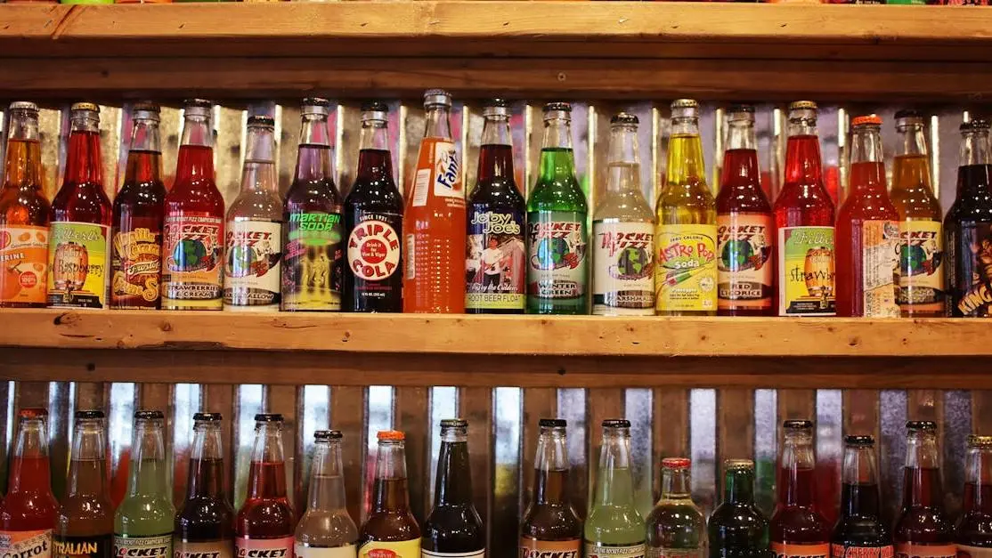 Colorful soda bottles on a shelf highlighting the effects of sugary drinks on teeth.