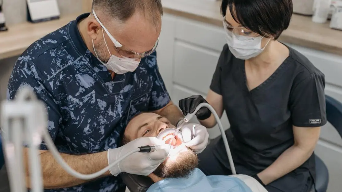 Dentist and assistant treating a patient in an emergency dental clinic