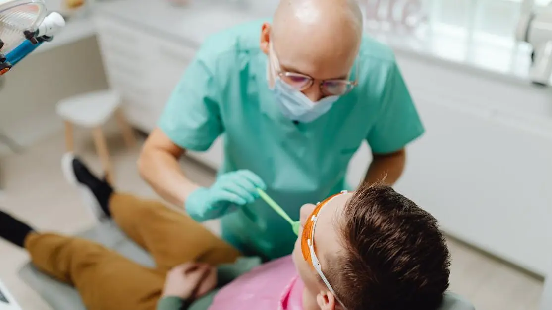 Experienced sedation dentist examining patient's teeth