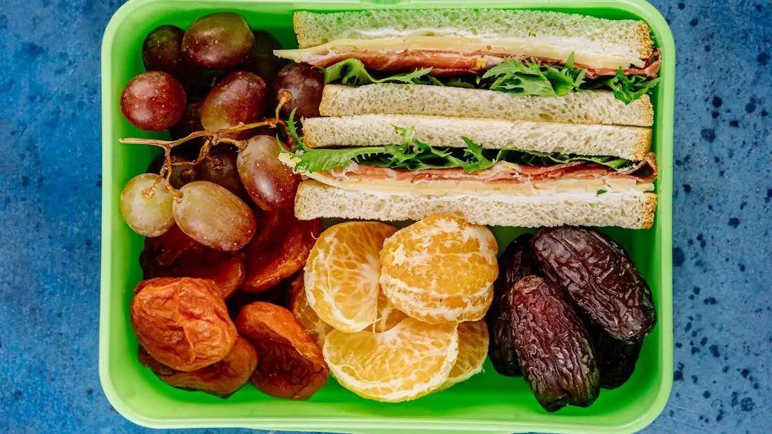 Healthy school lunch with sandwiches and fruit, promoting dental wellness.