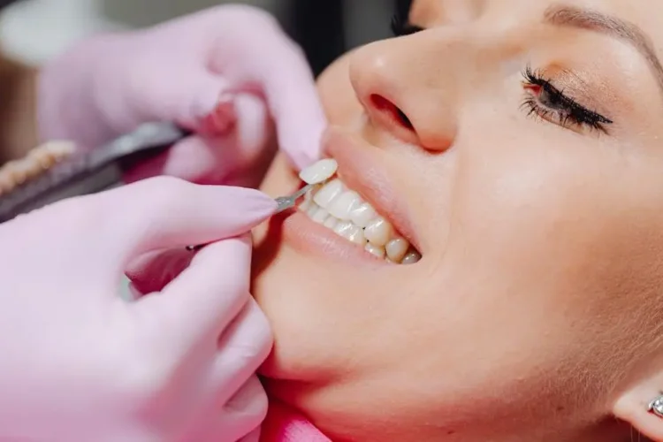 Dentist demonstrating how a crown is done on a patient