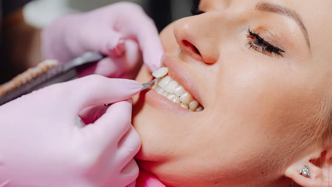 Dentist demonstrating how a crown is done on a patient