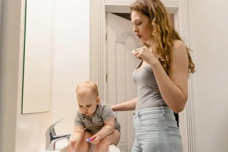 Mother and child brushing teeth, highlighting the importance of baby teeth.