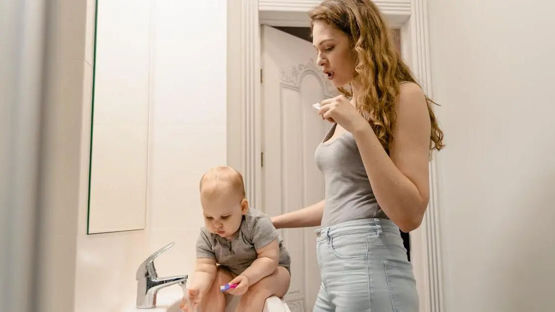 Mother and child brushing teeth, highlighting the importance of baby teeth.