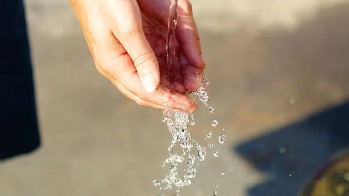 Hand under running water to improve dental hygiene.