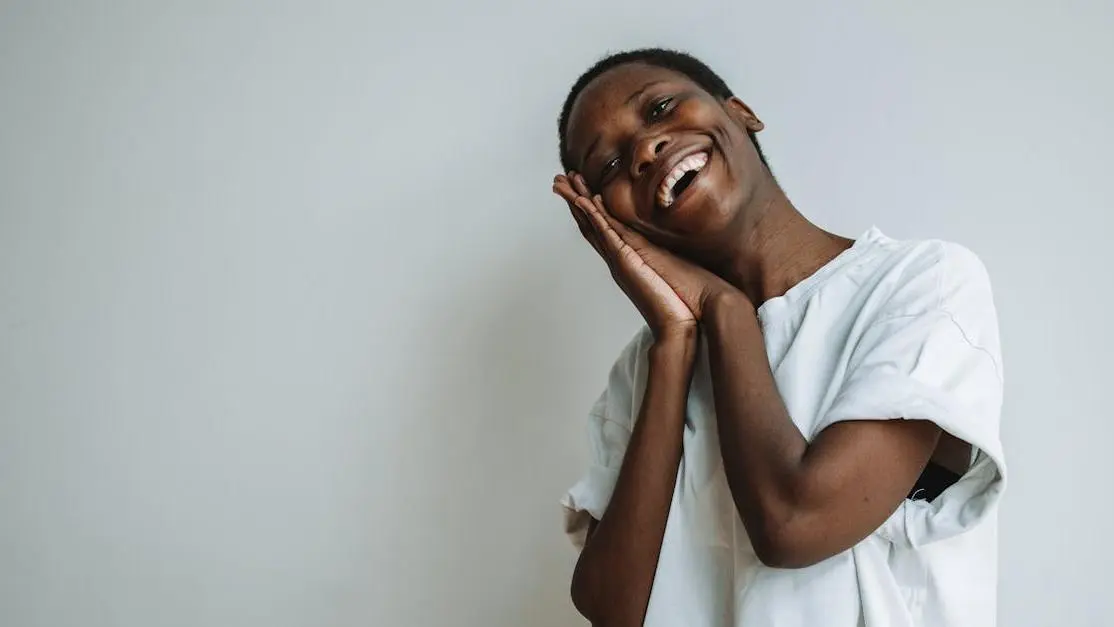 Smiling woman showing Invisalign clear aligners while leaning on her hands