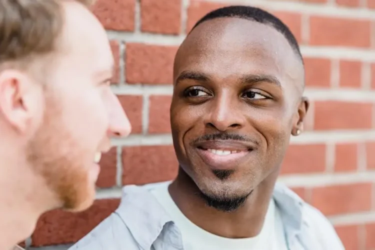 Smiling men showcasing results of Invisalign for crowded teeth