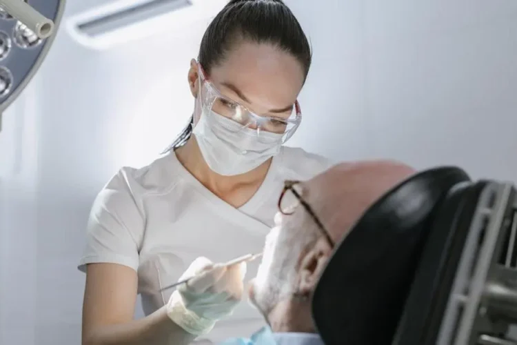 Dentist performing procedure with IV sedation on patient