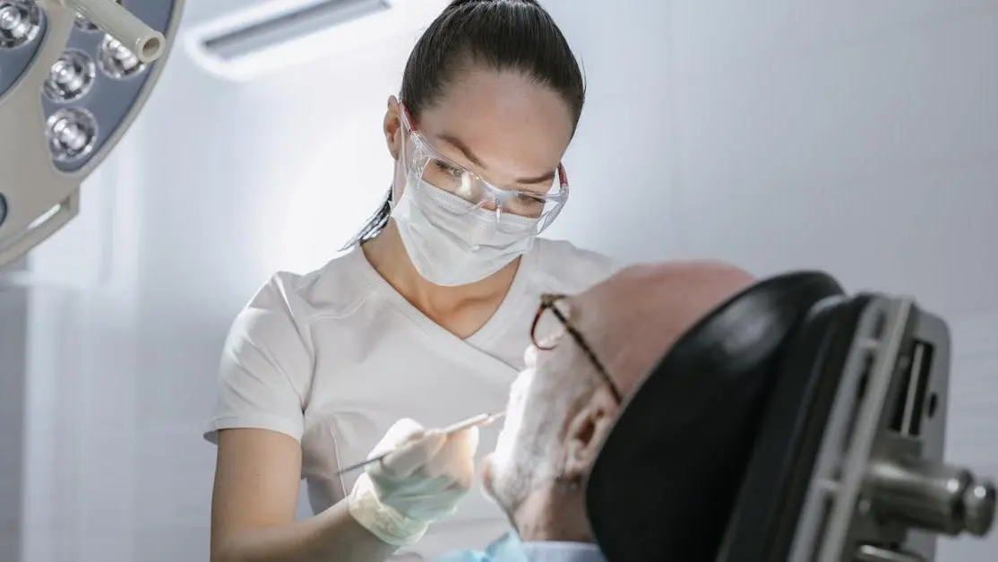 Dentist performing procedure with IV sedation on patient