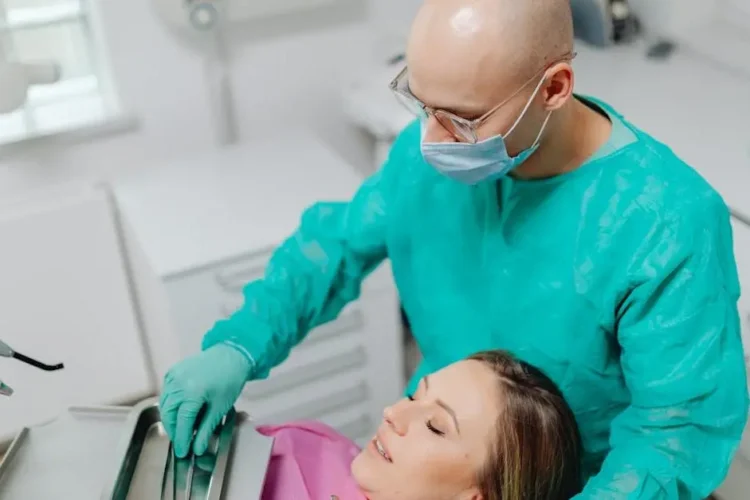 Dentist preparing patient for IV sedation during wisdom teeth extraction