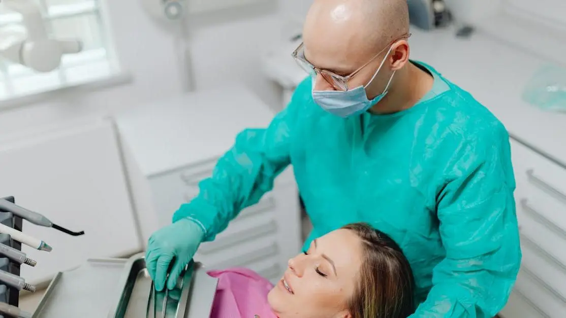 Dentist preparing patient for IV sedation during wisdom teeth extraction